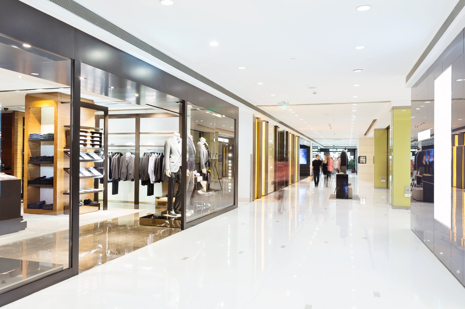Commercial interior with retail stores and a bright corridor